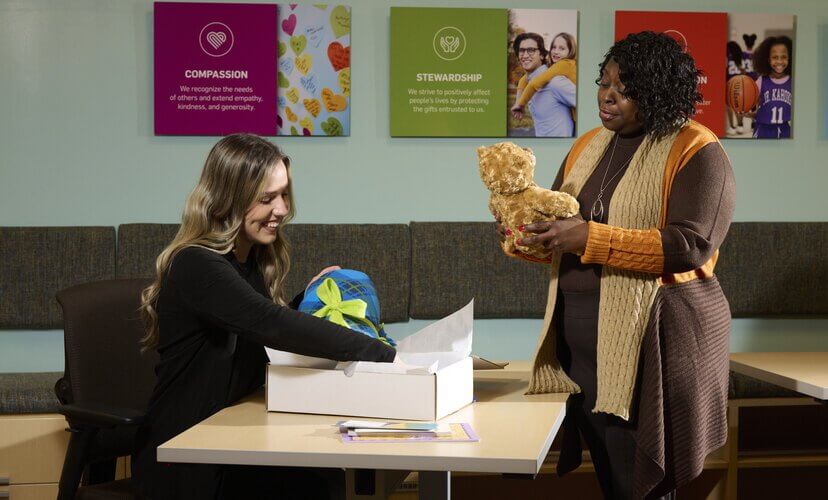 Emily and Nikki prepping an Aftercare box for a donor family